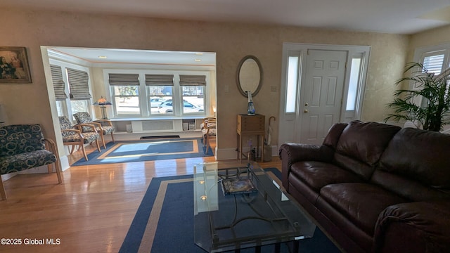 living area with wood finished floors and baseboards