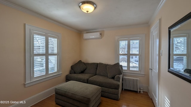 living area with radiator heating unit, a wall unit AC, wood finished floors, and crown molding