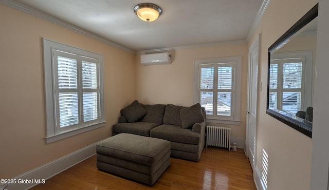 living area featuring wood finished floors, baseboards, ornamental molding, radiator, and a wall mounted air conditioner