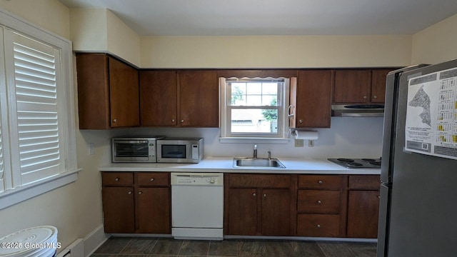 kitchen with stainless steel appliances, extractor fan, a sink, and light countertops