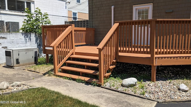 wooden deck featuring stairs and fence