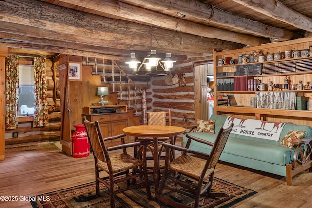 wine area with wooden ceiling, log walls, beamed ceiling, a notable chandelier, and wood-type flooring