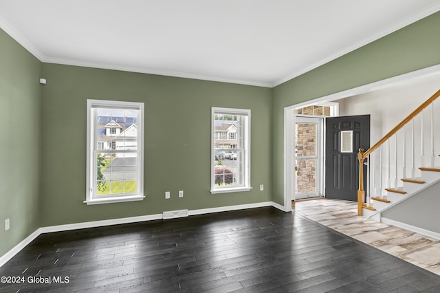 entrance foyer with crown molding and dark wood-type flooring