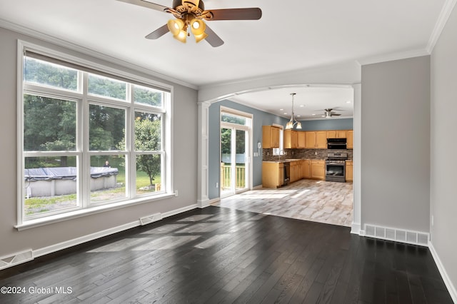 unfurnished living room with sink, ceiling fan, dark hardwood / wood-style flooring, and crown molding