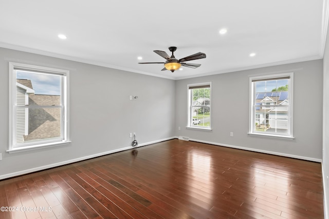 spare room featuring dark hardwood / wood-style flooring, ceiling fan, and crown molding