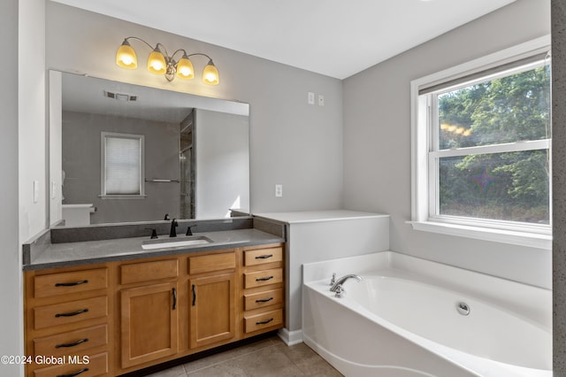 bathroom featuring a bathing tub, tile patterned flooring, and vanity