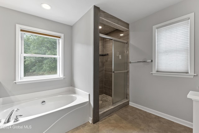 bathroom featuring independent shower and bath