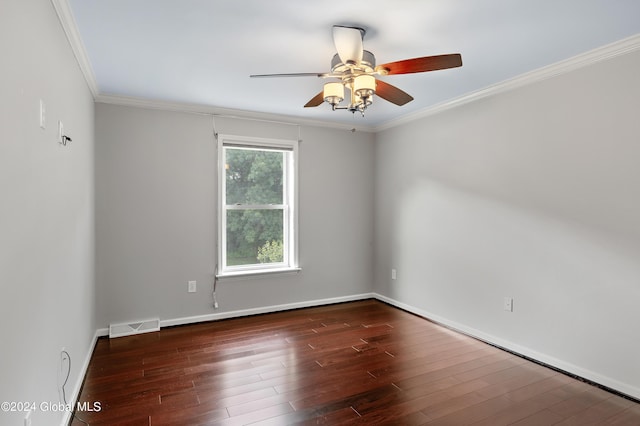 empty room with ceiling fan, dark wood-type flooring, and ornamental molding