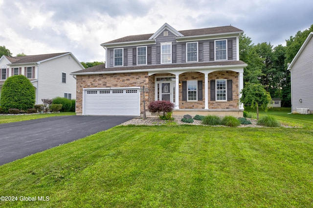 view of front of property featuring a garage and a front lawn