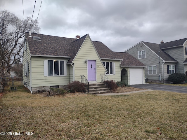 view of front of home with a garage and a front lawn