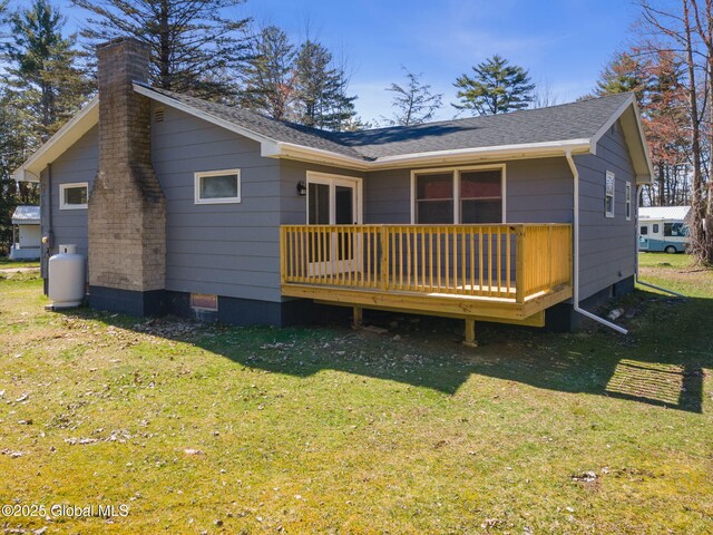 115 Chambers St, Broadalbin, NY 12025 - back of property with a chimney, a wooden deck, a yard, crawl space, and a shingled roof