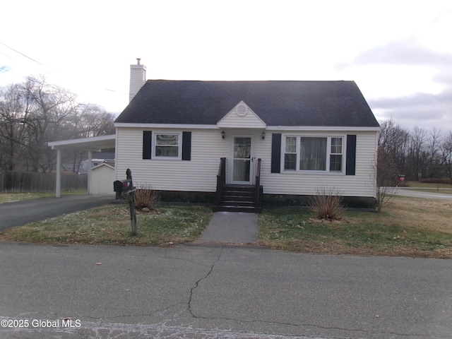 view of front facade with a front lawn and a carport