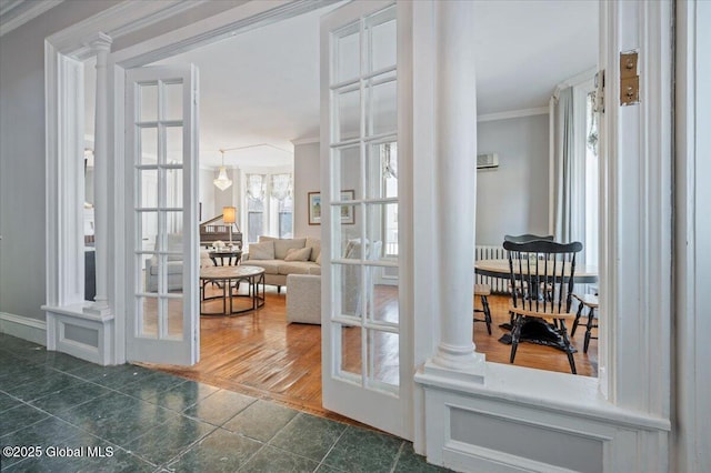 doorway to outside with french doors, crown molding, and decorative columns