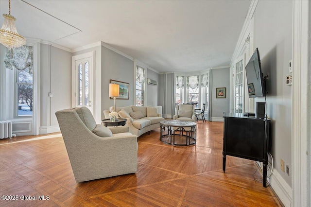 living room with ornamental molding, a wall mounted AC, radiator heating unit, and a wealth of natural light