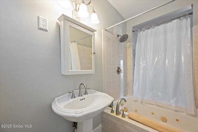 bathroom with shower / tub combo with curtain and sink