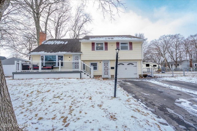 view of front of property featuring a garage and a wooden deck