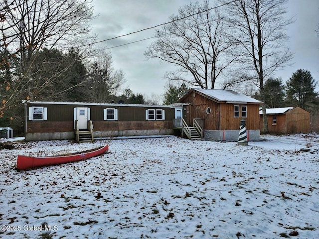 view of snow covered back of property