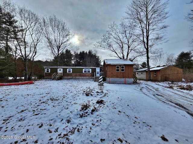 view of snow covered back of property