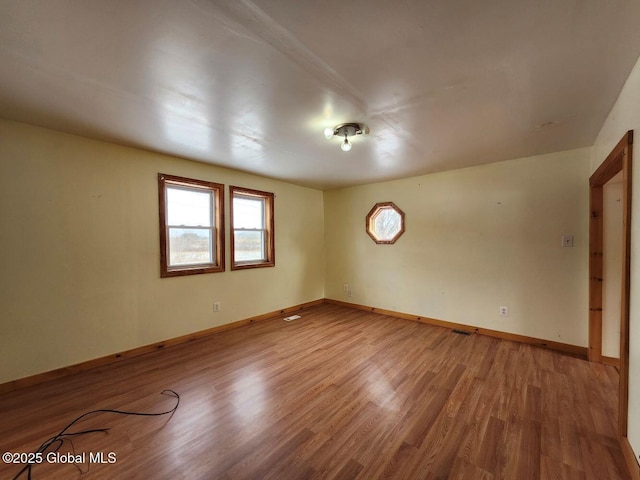 empty room with wood-type flooring