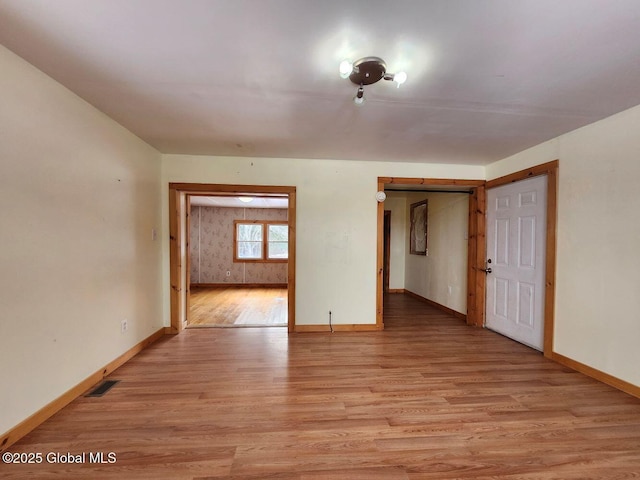 spare room featuring light hardwood / wood-style flooring