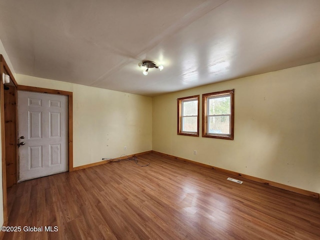 unfurnished room featuring hardwood / wood-style floors