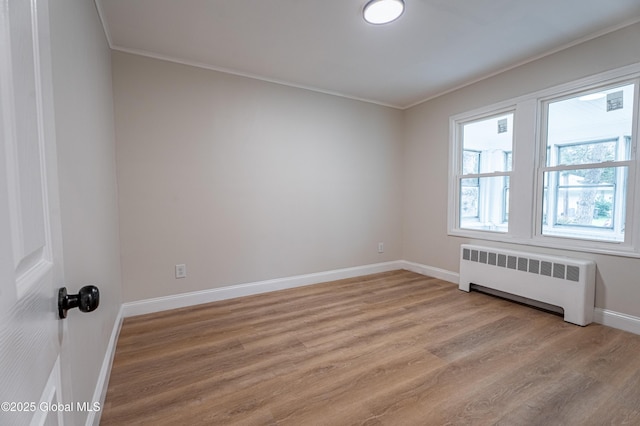 29 Lockrow Blvd, Colonie, NY 12205 - spare room featuring radiator, light wood-type flooring, and ornamental molding
