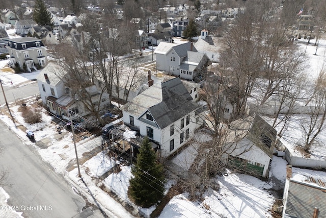 snowy aerial view with a residential view