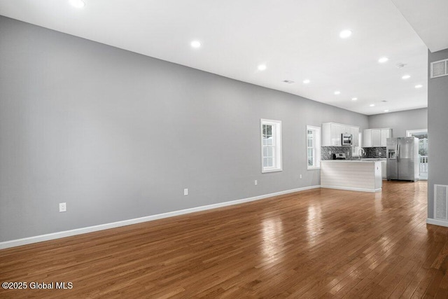 unfurnished living room with hardwood / wood-style flooring