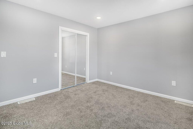 unfurnished bedroom with a closet and carpet floors