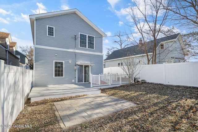 rear view of house with a patio and a wooden deck