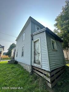 view of property exterior with a lawn