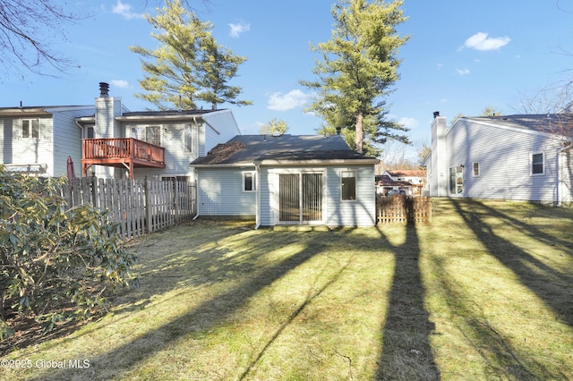 rear view of house with a yard