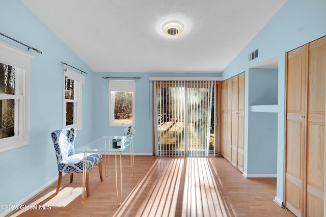 living area with light hardwood / wood-style flooring and lofted ceiling