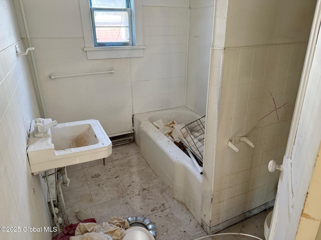 bathroom with a washtub and sink