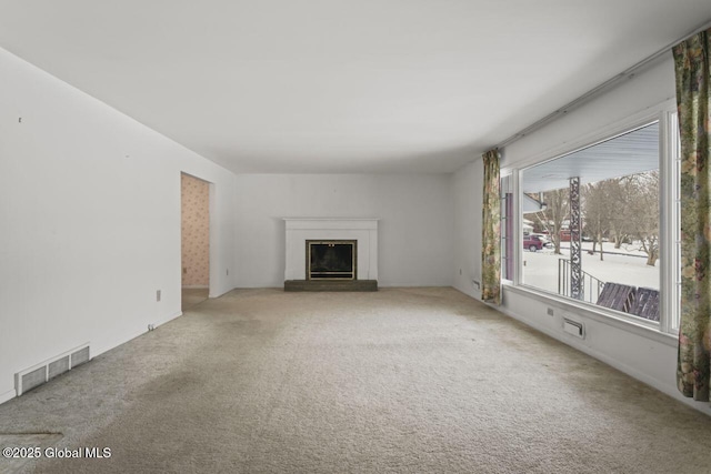 unfurnished living room featuring light colored carpet