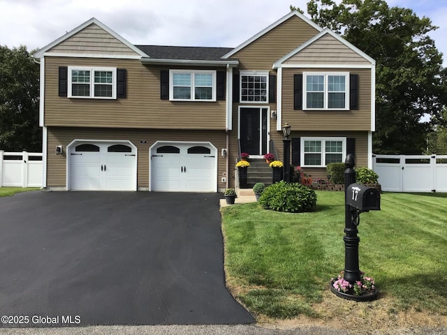 bi-level home featuring a front lawn and a garage