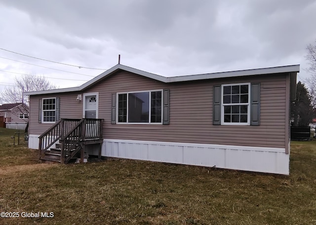 rear view of property featuring a lawn