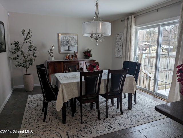 tiled dining space featuring a chandelier