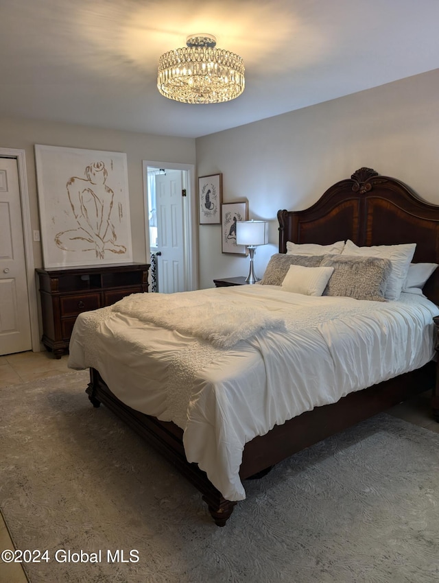 bedroom with a notable chandelier