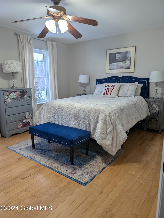 bedroom with hardwood / wood-style floors and ceiling fan