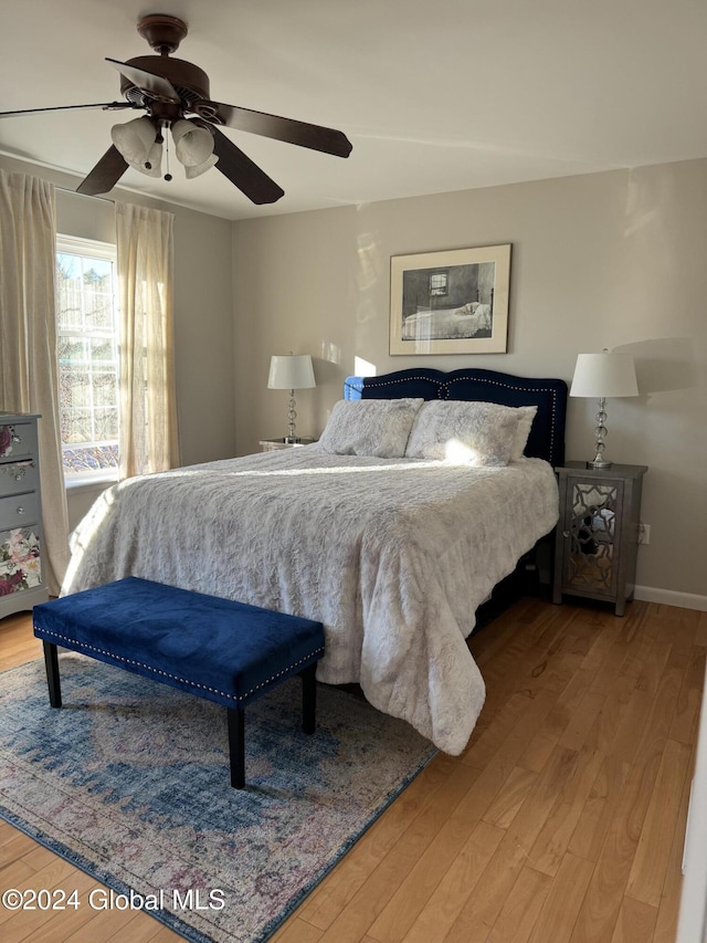 bedroom featuring wood-type flooring and ceiling fan