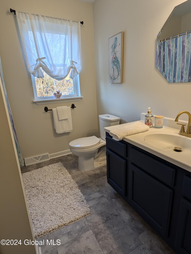 bathroom with vanity and toilet