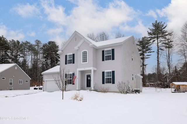 view of front of property with a garage and central air condition unit