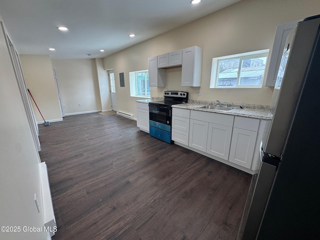 kitchen with range with electric cooktop, dark wood-style flooring, a sink, white cabinetry, and freestanding refrigerator