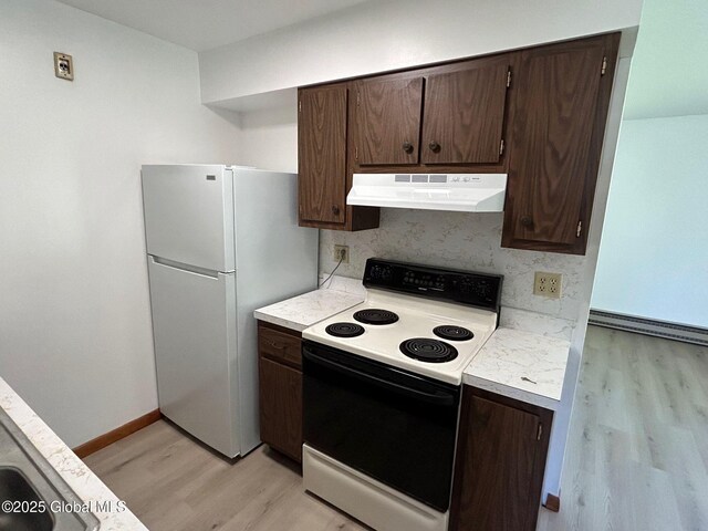 kitchen featuring dark brown cabinetry, ventilation hood, light countertops, and range with electric stovetop