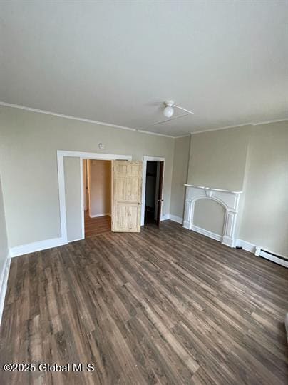 unfurnished living room featuring dark hardwood / wood-style floors and ornamental molding