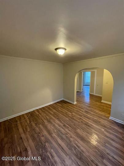 spare room featuring dark wood-type flooring