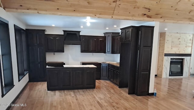 kitchen with a center island, wooden ceiling, and light hardwood / wood-style floors