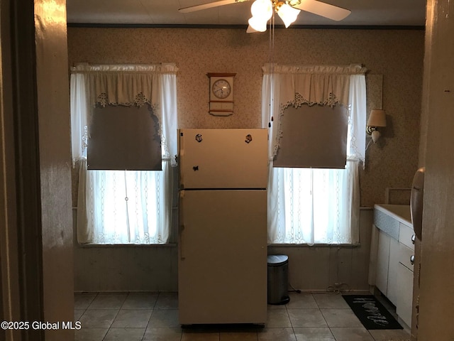 24 4th Ave, Gloversville, NY 12078 - kitchen with ceiling fan, white refrigerator, light tile patterned floors, and ornamental molding