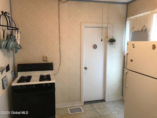 24 4th Ave, Gloversville, NY 12078 - kitchen featuring light tile patterned flooring and white appliances